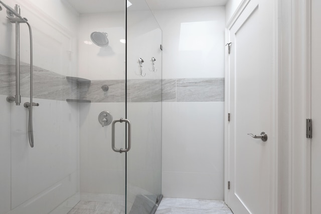 bathroom with a shower with door