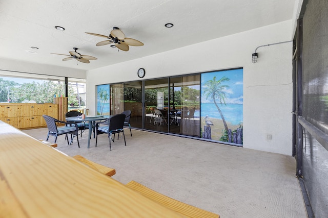 sunroom / solarium featuring ceiling fan