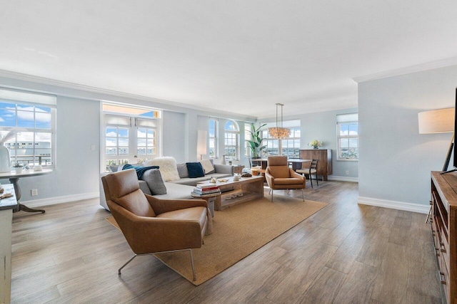 living room featuring light hardwood / wood-style floors and crown molding