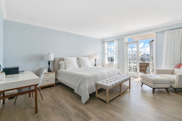 bedroom with hardwood / wood-style flooring, access to exterior, and crown molding