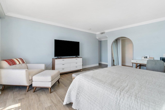 bedroom featuring light wood-type flooring and crown molding