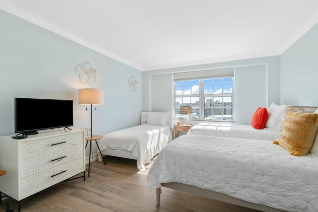 bedroom featuring hardwood / wood-style flooring and crown molding