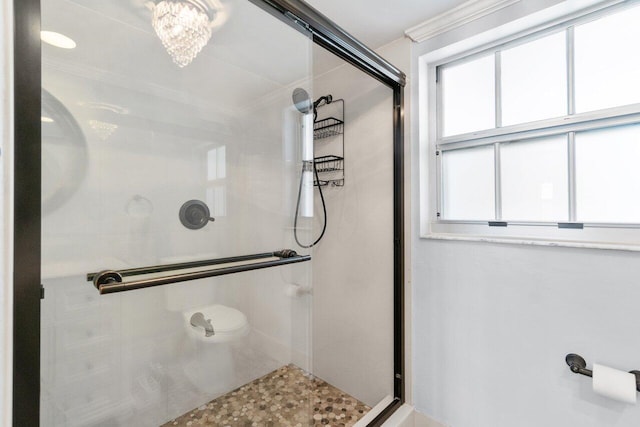 bathroom featuring walk in shower and a chandelier