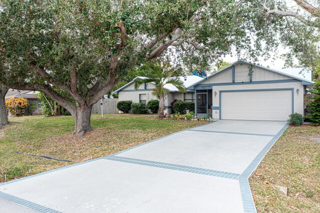 ranch-style house with a front yard and a garage