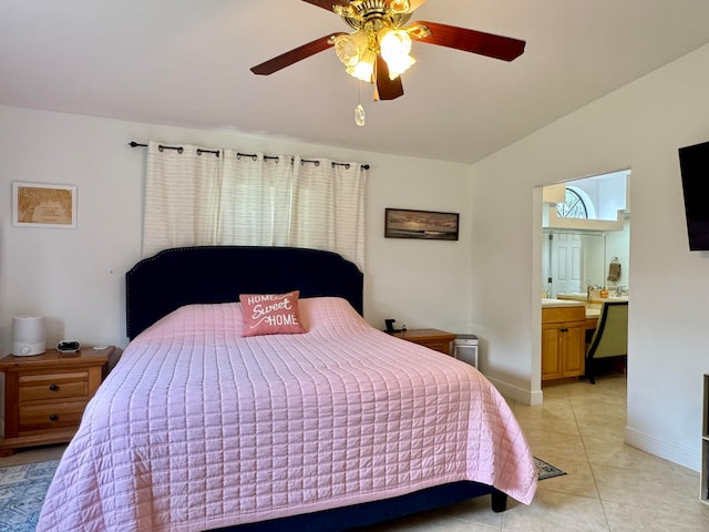 bedroom with ceiling fan, light tile patterned floors, and ensuite bathroom