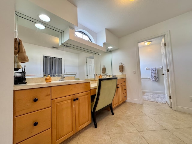 bathroom featuring tile patterned flooring and vanity