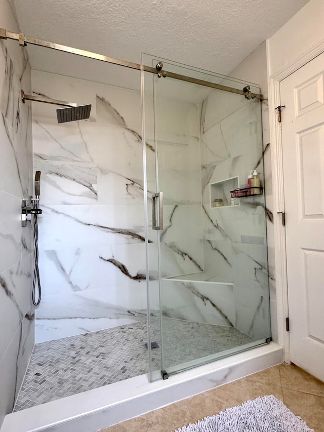 bathroom featuring tile patterned floors, a textured ceiling, and walk in shower