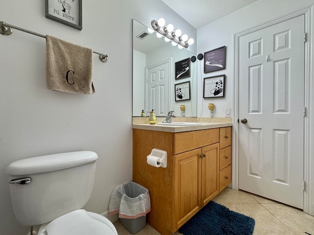 bathroom with tile patterned floors, vanity, and toilet