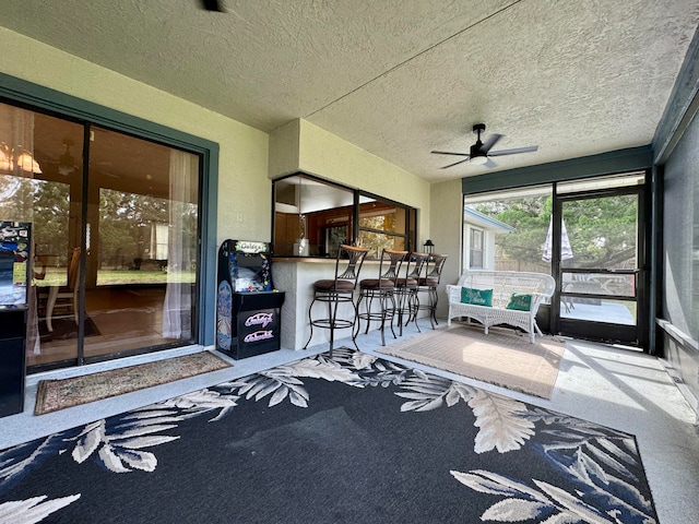 sunroom with ceiling fan