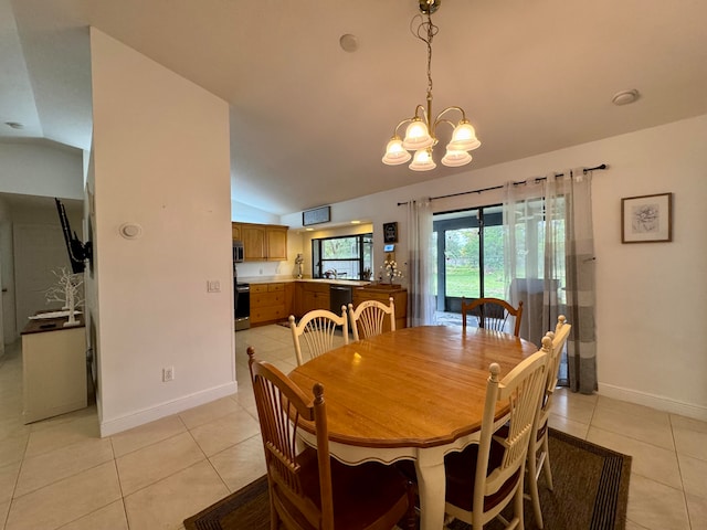 dining area featuring light tile patterned floors, vaulted ceiling, and an inviting chandelier