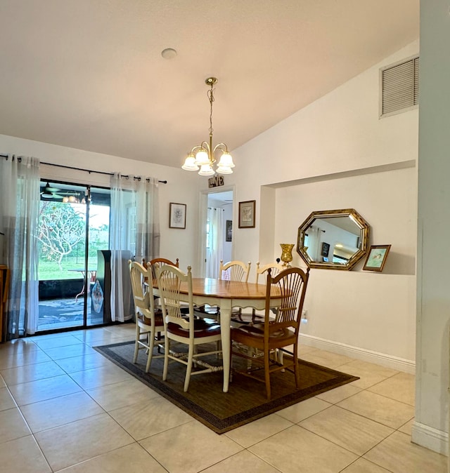 dining area with light tile patterned floors, a chandelier, and vaulted ceiling