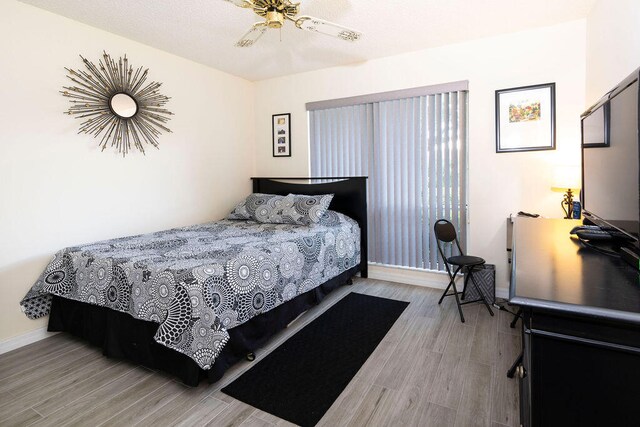 bedroom featuring hardwood / wood-style floors and ceiling fan