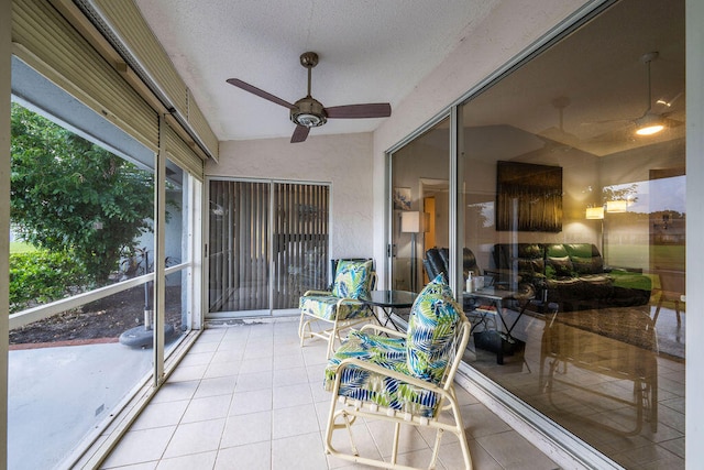 sunroom with lofted ceiling and ceiling fan