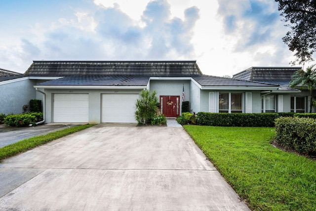 single story home with a garage and a front yard