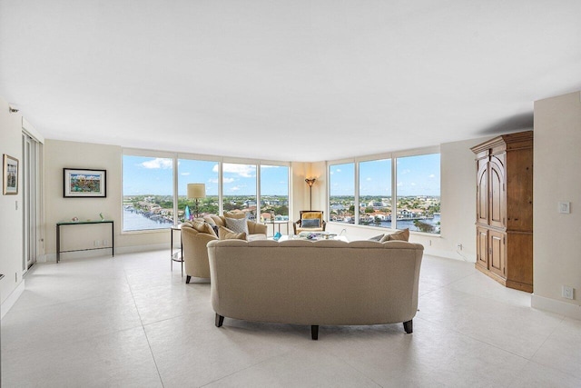 living room featuring a wall of windows and a water view