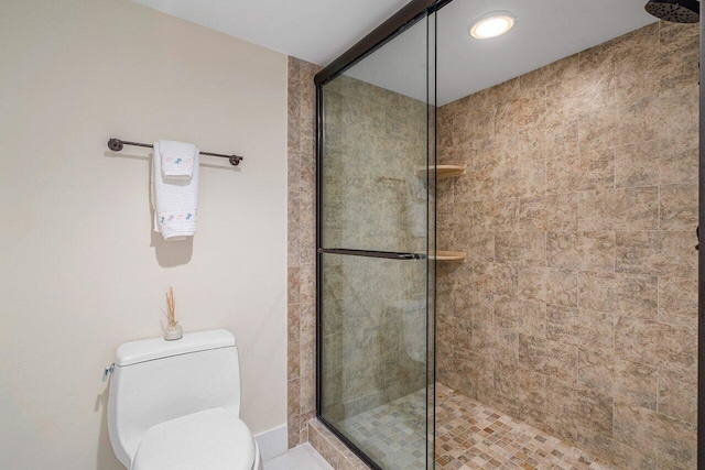 bathroom featuring toilet and an enclosed shower