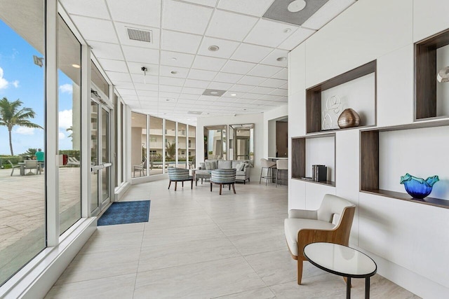 sunroom featuring a paneled ceiling