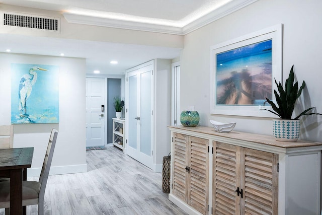 corridor featuring light hardwood / wood-style floors and ornamental molding