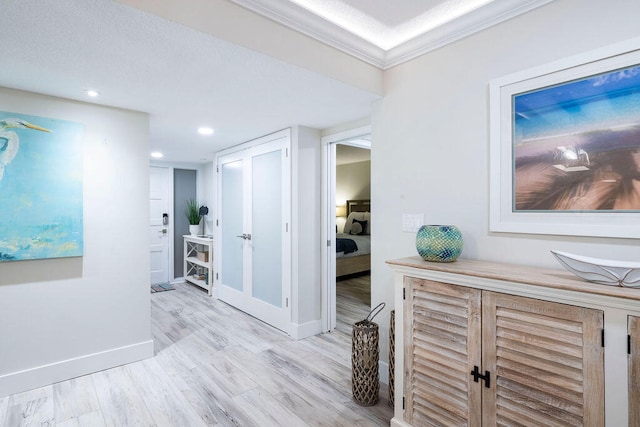 hallway featuring light hardwood / wood-style flooring and crown molding