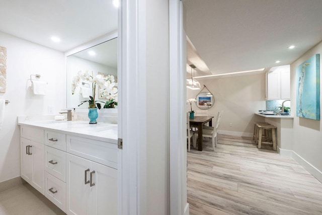 bathroom with wood-type flooring, backsplash, and vanity