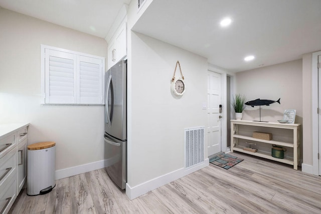 clothes washing area featuring light hardwood / wood-style flooring