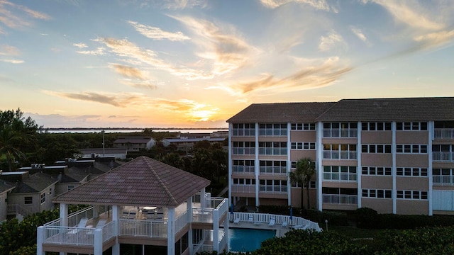 outdoor building at dusk featuring a water view