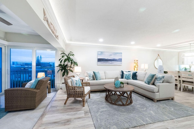 living room with ceiling fan and light hardwood / wood-style flooring