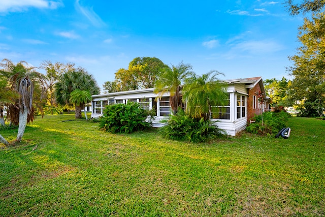 rear view of property featuring a yard