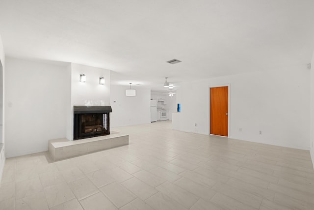 unfurnished living room with ceiling fan