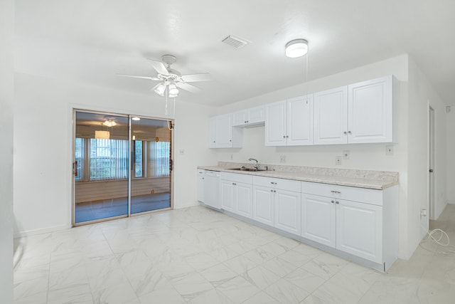 kitchen featuring ceiling fan, sink, white dishwasher, and white cabinets