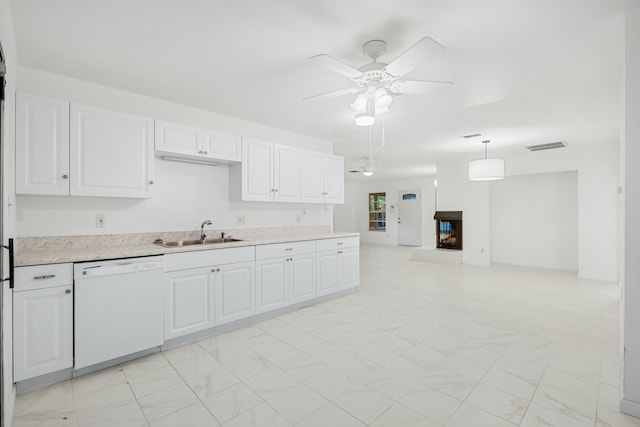 kitchen featuring sink, white cabinets, white dishwasher, and decorative light fixtures