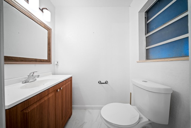 bathroom featuring toilet and vanity