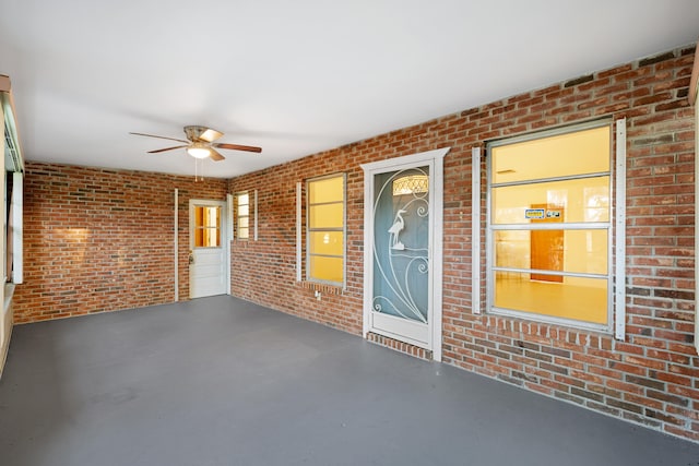 interior space with ceiling fan