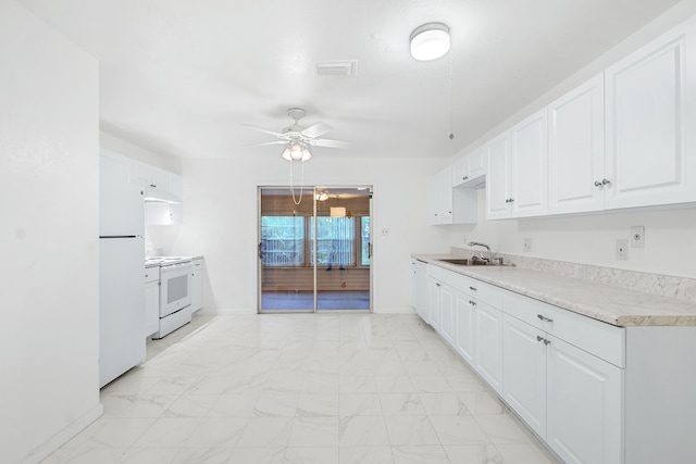 kitchen featuring ceiling fan, sink, white appliances, and white cabinets