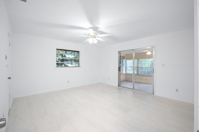 unfurnished room with ceiling fan and a wealth of natural light