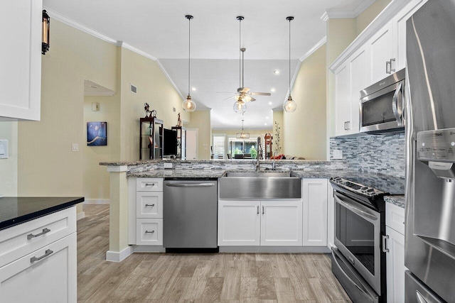 kitchen with stainless steel appliances, white cabinetry, ceiling fan, and sink