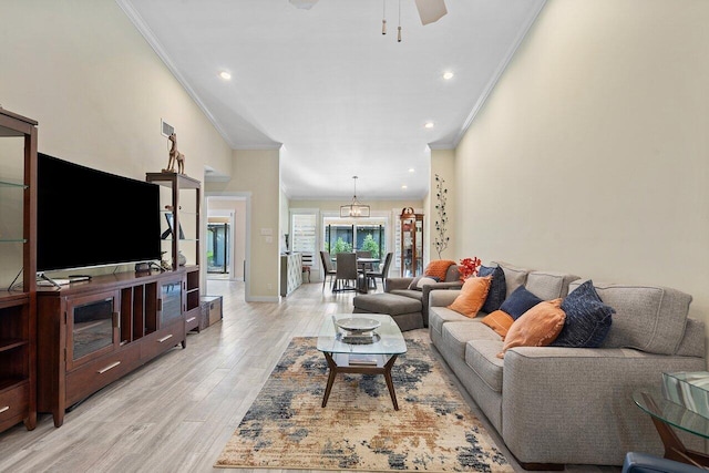 living room with light wood-type flooring, ceiling fan, and crown molding