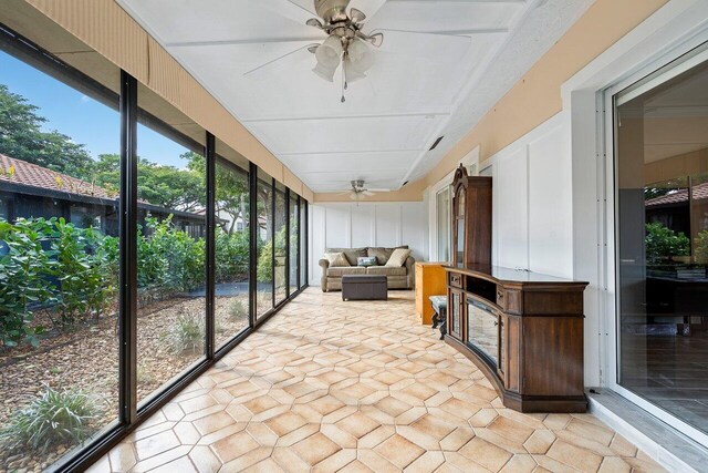 sunroom / solarium featuring ceiling fan