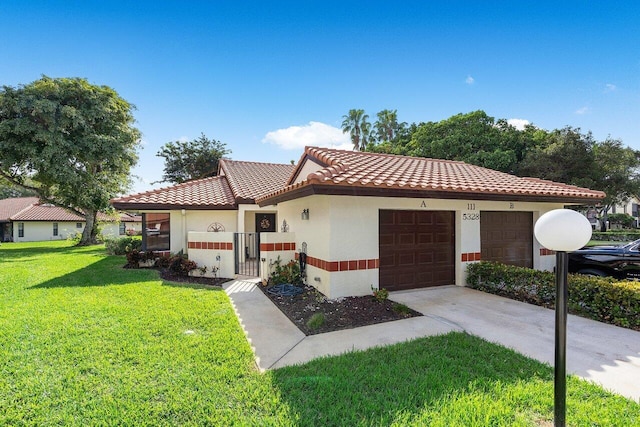 mediterranean / spanish home with a garage and a front yard