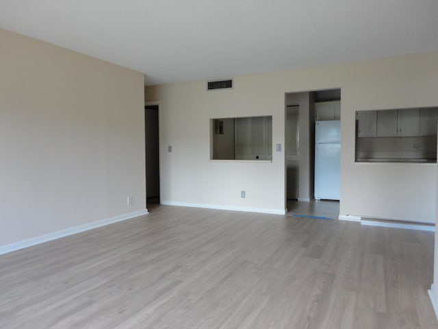 unfurnished living room with light hardwood / wood-style floors