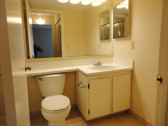 bathroom featuring toilet, vanity, and tile patterned floors