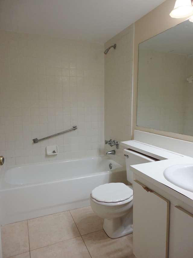 full bathroom with toilet, tiled shower / bath combo, vanity, and tile patterned flooring