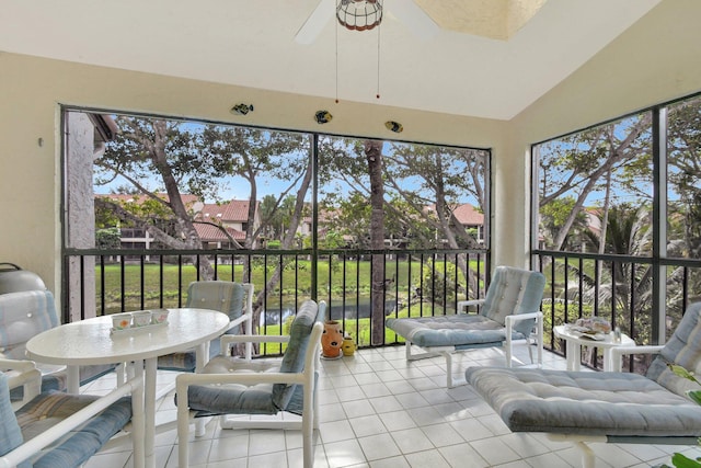 sunroom featuring a healthy amount of sunlight, ceiling fan, and vaulted ceiling