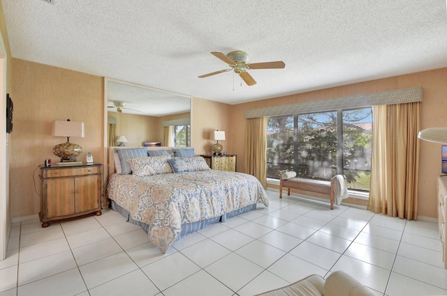 tiled bedroom featuring a textured ceiling and ceiling fan