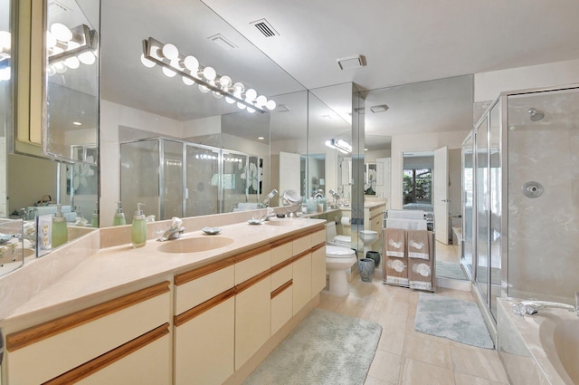 full bathroom with toilet, tile patterned flooring, vanity, and separate shower and tub