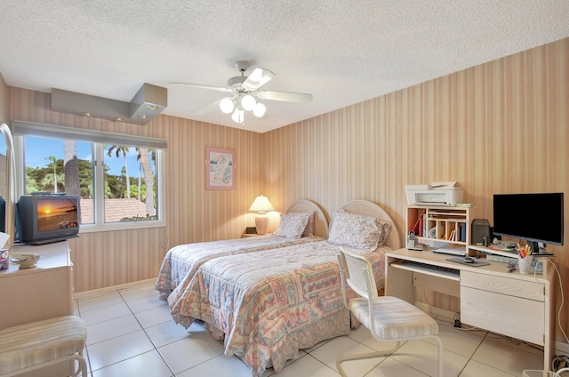 tiled bedroom with a textured ceiling and ceiling fan