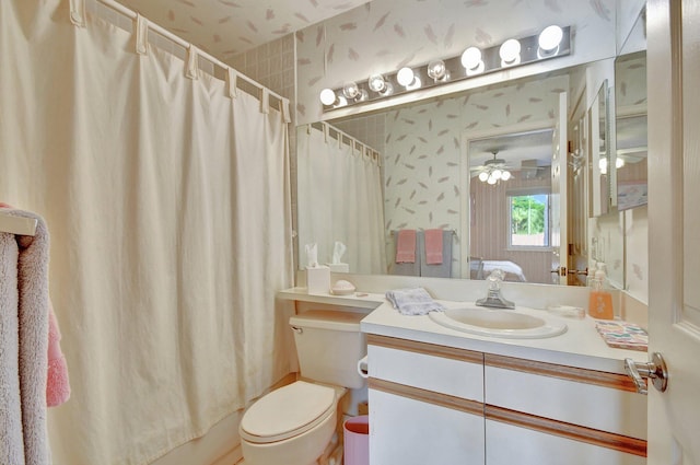 full bathroom featuring shower / bath combo, vanity, ceiling fan, and toilet