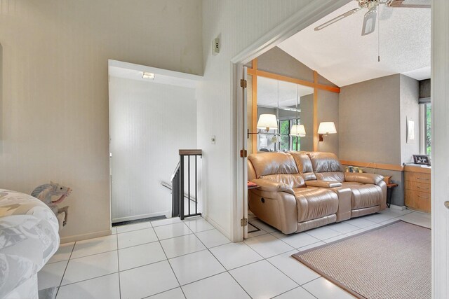 living room featuring plenty of natural light, light tile patterned floors, and vaulted ceiling