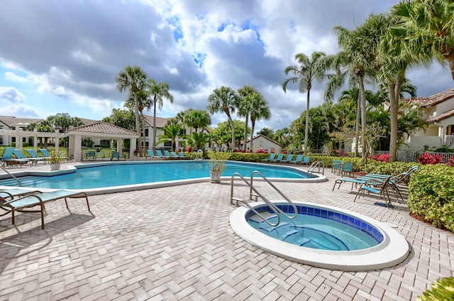 view of swimming pool featuring a patio and a community hot tub