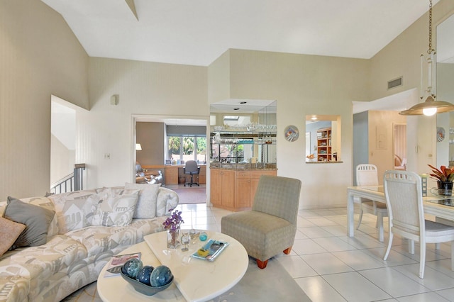 living room with light tile patterned floors and a high ceiling